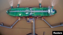 CHINA -- FILE PHOTO: An oil tanker unloads crude oil at a crude oil terminal in Zhoushan, Zhejiang province, China July 4, 2018. Picture taken July 4, 2018. 