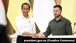 Indonesia's president, Joko Vidodo (left), says he was given the message from Ukrainian President Volodymyr Zelenskiy (right) during a stopover in Kyiv on June 29. 