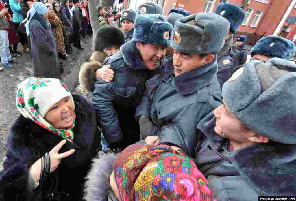 Supporters of detained opposition lawmakers demonstrate in front of a court in the Kyrgyz capital, Bishkek, as the lawmakers stood trial on January 25 for their role in organizing a protest.