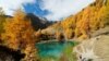 Hikers enjoy a warm autumn day at Lac Bleu near Arolla in the Val d&#39;Herens, Switzerland. (Reuters/Denis Balibouse)