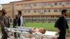 FILE: An Afghan boy who was injured in an airstrike on a religious seminary receives medical treatment at a hospital in the northeastern Afghan city Kunduz in April.