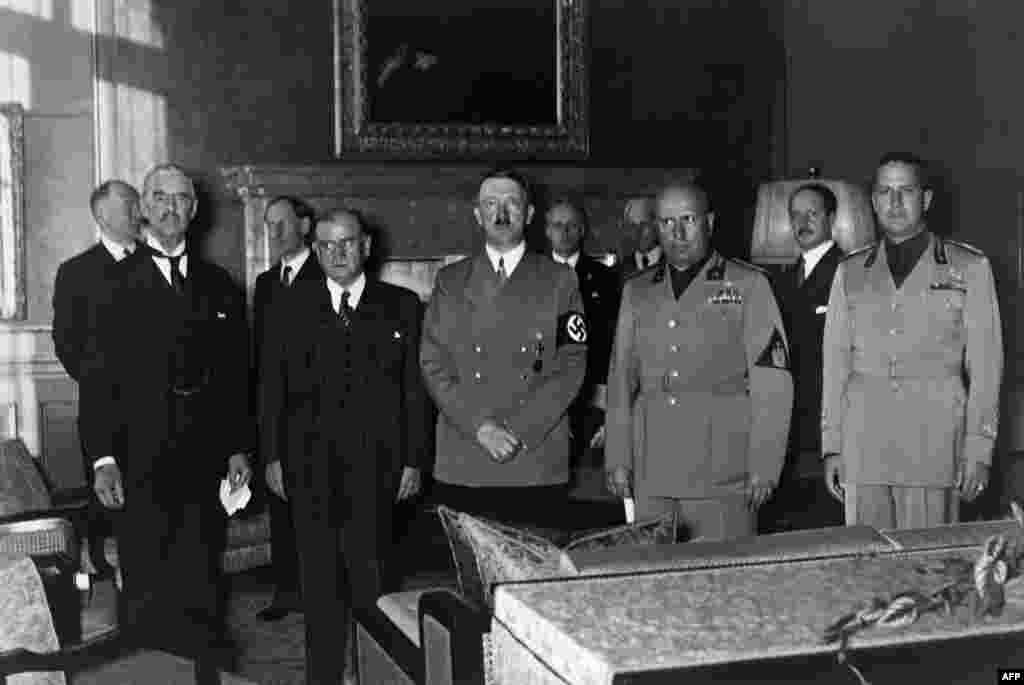 Prime Ministers (left to right) Lord Neville Chamberlain of the United Kingdom and Edouard Daladier of France, German Chancellor Adolf Hitler, Italian Prime Minister Benito Mussolini and Foreign Minister Count Gian Galeazzo Ciano gather in Munich on September 29, 1938, to sign the Munich treaty between Nazi Germany, France, Italy, and the United Kingdom, authorizing Hitler to annex the Czech territory called the Sudetenland.