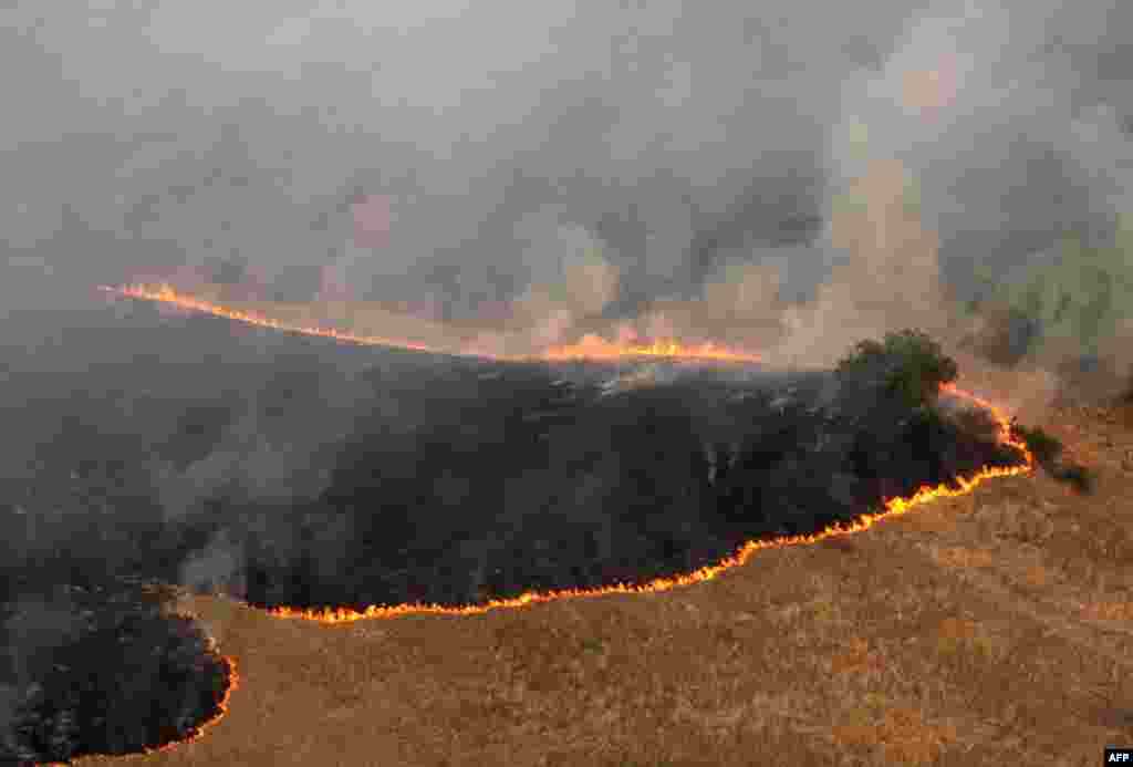 A wildfire is seen from the air near the Serbian village of Dubovo on August 22. An unprecedented drought and soaring temperatures in the Balkans caused a string of forest fires and serious damage to agriculture in the region. (AFP/Nebojsha Markovic)