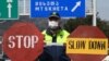 A Georgian policeman stands guard at a checkpoint in Tbilisi on April 1. They say numbers never lie. But as governments tabulate figures for COVID-19 infections and deaths, experts say the data is likely incomplete.