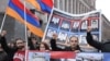 Armenia -- Opposition demonstrators hold up pictures of 10 men killed in the 2008 post-election violence in Yerevan, 1Mar2013.