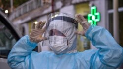 ARMENIA - A doctor adjusts a protective face mask at the Grigor Lusavorich Medical Centre in Yerevan on May 27, 2020.