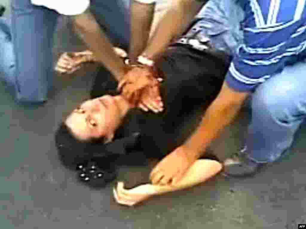 A still from a video shows Iranian men trying to help Neda Agha-Soltan after she was fatally wounded by gunfire during a protest in Tehran on June 20. Her image was adopted as a symbol of resistance against the Iranian regime.
