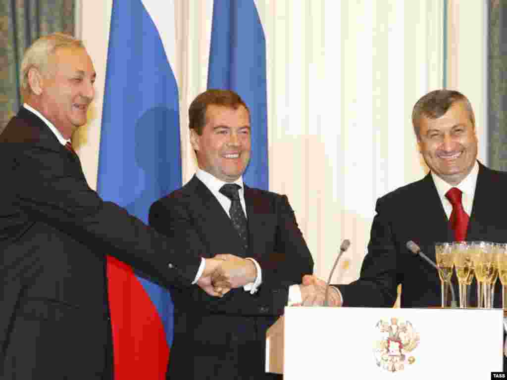 Russian President Dmitry Medvedev (center) shakes hands with the leaders of South Ossetia and Abkhazia, Eduard Kokoity (right) and Sergei Bagapsh, in Moscow in September 2008. On August 26, 2008, Russia recognized the two regions as independent states. Russia has maintained troops in both regions, which have been recognized as independent by only a handful of other countries, including Syria in 2018.