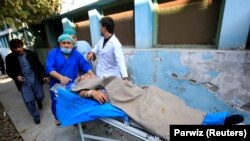 Hospital workers carry Tetsu Nakamura to a hospital after an attack in Jalalabad on December 4.