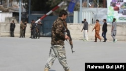 An Afghan soldier walks near the site of an explosion in Kabul in March.