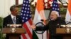 Indian Prime Minister Narendra Modi (R) reaches out to shake hands with U.S. President Barack Obama on January 25.