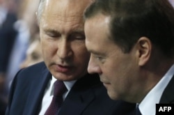 Russian President Vladimir Putin (left) and Prime Minister Dmitry Medvedev attend a United Russia party convention in Moscow on December 23.