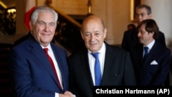 U.S. Secretary of State Rex Tillerson (left) shakes hands with French Foreign Minister Jean-Yves Le Drian before a meeting in Paris on January 23.