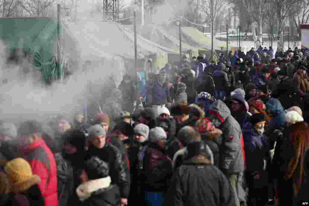 Local residents of Avdiyivka, the scene of some of the fiercest fighting, wait to receive food provided by rescue workers on February 1.