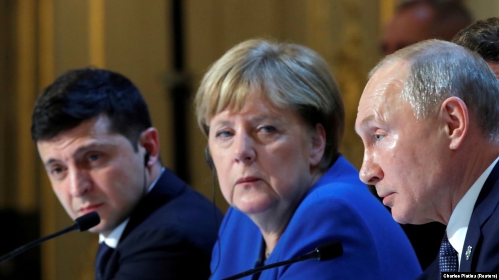 FRANCE -- Ukraine's President Volodymyr Zelenskiy, German Chancellor Angela Merkel and Russia's President Vladimir Putin attend a joint news conference after a Normandy-format summit in Paris, France December 10, 2019. 