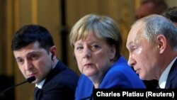 Ukraine's President Volodymyr Zelenskiy, German Chancellor Angela Merkel, and Russia's President Vladimir Putin attend a joint news conference after a summit in Paris on December 10.