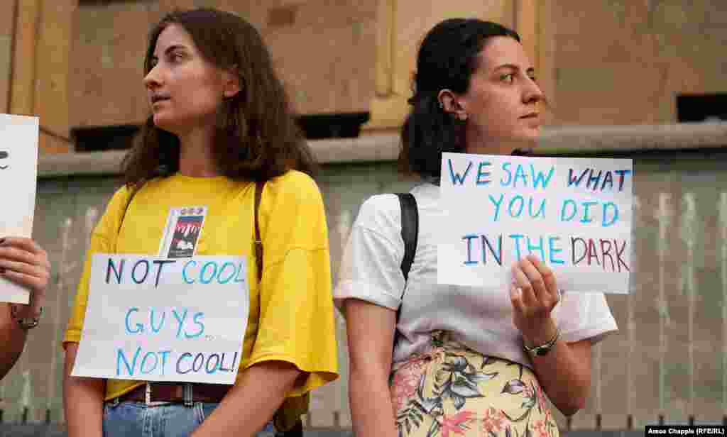 Young women with posters apparently referencing the police&#39;s use of force on June 20.