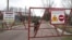 Belarus -- An employee closes the gate at the entrance to the exclusion zone around the Chornobyl nuclear reactor, southeast of Minsk, April 21, 2015
