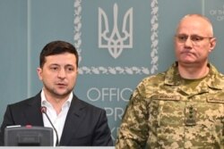 Ukrainian President Volodymyr Zelensky speaks, flanked by Ruslan Khomchak, military commander of the Armed Forces of Ukraine, at a briefing following an outbreak of violence with Russia-backed separatists, in Kyiv on February 18.