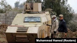 Iraqi soldiers inspect a captured vehicle designed for a suicide car bombing in Mosul, in northern Iraq. Crudely armored vehicles like this are packed with explosives and can be extremely <strong><a href="https://www.youtube.com/watch?v=9DgiYXt7EQo" target="_blank">difficult to stop</a> </strong>when driven straight at coalition battle positions.