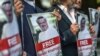 Protesters hold pictures of missing journalist Jamal Khashoggi during a demonstration in front of the Saudi Arabian Consulate in Istanbul on October 5. (AFP/Ozan Kose)