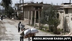 Syrians pack their belongings as they flee their home in the town of Utaya in the Syrian rebel enclave of eastern Ghouta on March 1.