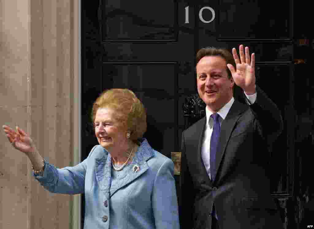 U.K. -- Former British Prime Minister Baroness Margaret Thatcher waves to photographers as she stands with current British Prime Minister, David Cameron, on the doorstep of 10 Downing Street, 08Jun2010
