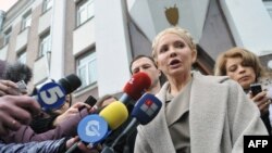 Former Prime Minister Yulia Tymoshenko speaks to the media in front of the prosecutor's office after her interrogation. She and other former members of her cabinet have faced charges they say are politically motivated.