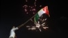 Iraqi Kurds wave the Kurdish flag as they celebrate in the streets of the northern city of Irbil on September 25.