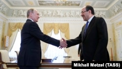 Russian President Vladimir Putin (left) meets with Iraqi Vice President Nuri al-Maliki in St. Petersburg on July 25.