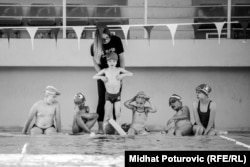 A trainer works with young swimmers in Sarajevo