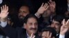 Iftikhar Muhammad Chaudhry (left) waves to supporters at his residence in Islamabad after his reinstatement was announced