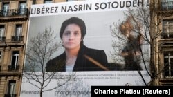 FRANCE -- A banner with a giant portrait of jailed Iranian lawyer Nasrin Sotoudeh by Arash Ashourinia is seen on the headquarters of the French National Bar Council, demanding her release, in Paris, March 28, 2019