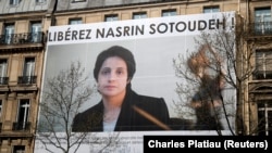 A banner with a giant portrait of jailed Iranian lawyer Nasrin Sotoudeh is seen on the headquarters of the French National Bar Council, demanding her release, in Paris, March 28, 2019