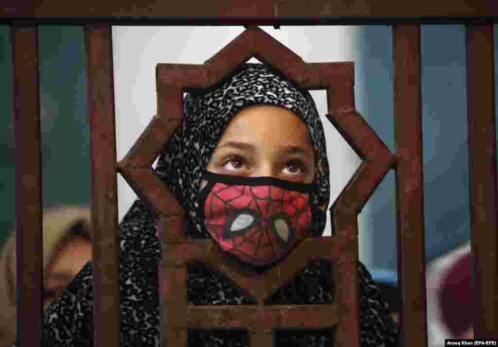 A Kashmiri girl looks on as the relics of Sheikh Syed Abdul Qadir Jeelani go on display at his shrine in Srinagar, India. (epa-EFE/Farooq Khan)