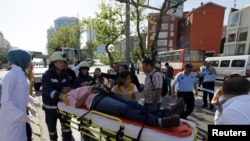 A wounded man is taken to an ambulance following an explosion in Istanbul on May 26.