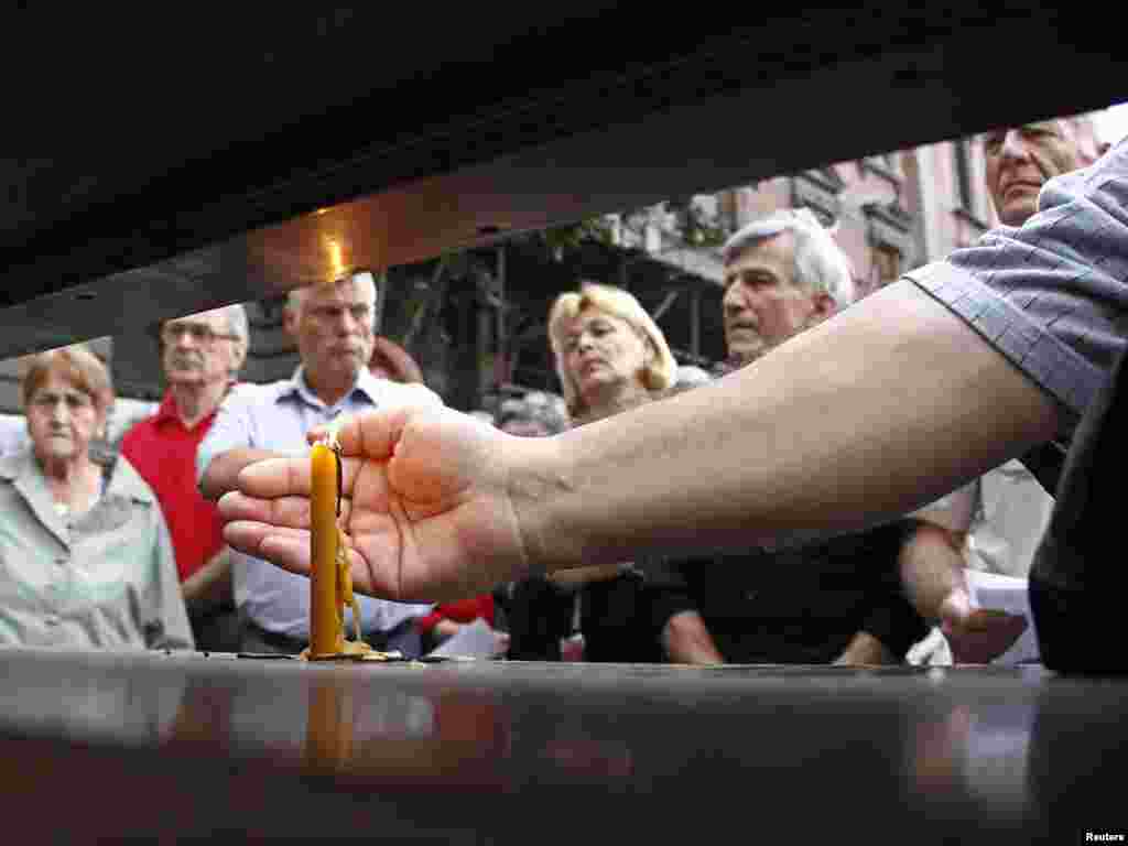 Belgrade residents attend a protest in the city center on July 24 after a Hungarian court cleared 97-year-old Sandor Kepiro of involvement in the massacre of more than 1,000 civilians in the Serb city of Novi Sad during World War II. (REUTERS/Ivan Milutinovic)