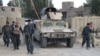 Afghan security personnel keep watch as heavy fighting erupted near the airport on the outskirts of Kunduz on September 29.