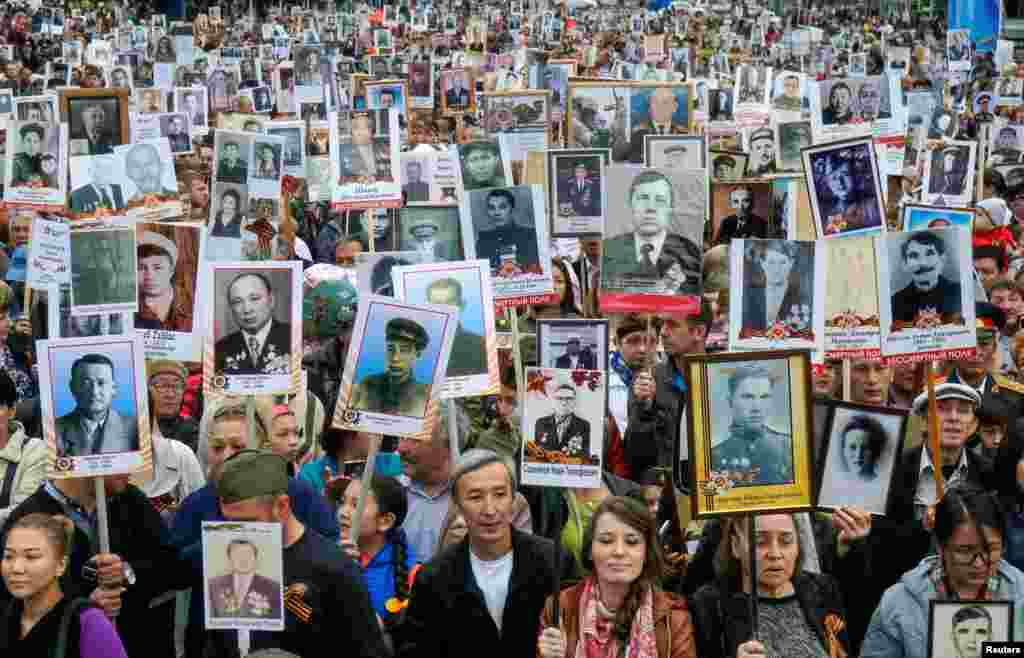 People carrying portraits of deceased relatives who took part in World War II, march in a parade during Victory Day commemorations in Almaty, Kazakhstan, on May 9. (Reuters/Shamil Zhumatov)