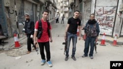 Syrian rebels stand in the Khalidiya district of the central city of Homs on May 3.