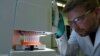 Employee Philipp Hoffmann, of German biopharmaceutical company CureVac, demonstrates research workflow on a vaccine for the coronavirus (COVID-19) disease at a laboratory in Tuebingen