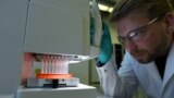 Employee Philipp Hoffmann, of German biopharmaceutical company CureVac, demonstrates research workflow on a vaccine for the coronavirus (COVID-19) disease at a laboratory in Tuebingen