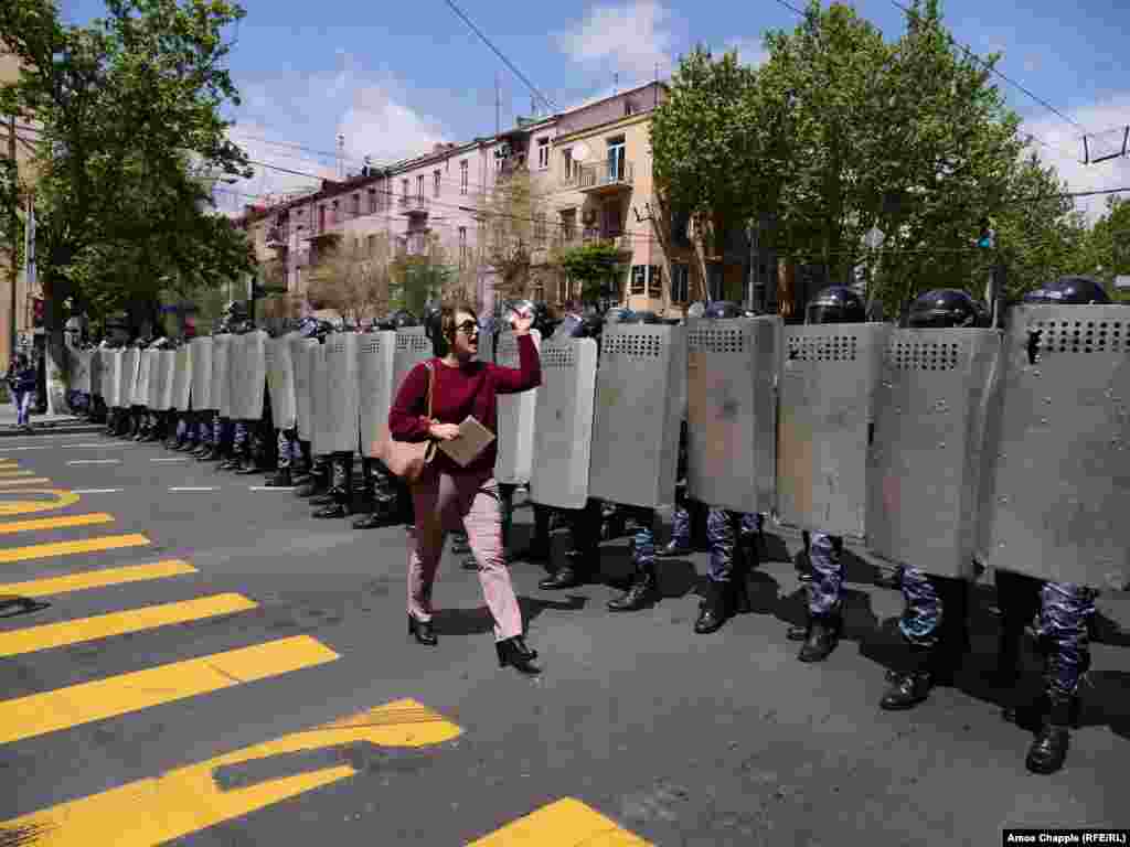 An Armenian woman confronts a line of riot police blocking Yerevan's Mashtots avenue: "I'm a journalist but before I'm a journalist I'm a citizen, and before you are police you are all citizens of Armenia!" (RFE/RL /Amos Chapple)