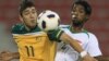 Iraqi player Jasim Faisal (right) fights for the ball with Dimitrios Petratos of Australia during their qualifying match in Doha in November.