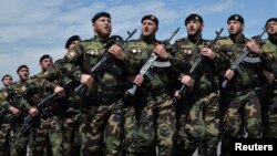 Russian servicemen march during a Victory Day military parade in Grozny in May.