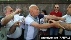 Armenia -- Opposition lawmaker Hrant Bagratian (L) clashes with a protester (R) outside the parliament building in Yerevan, 27June, 2016 