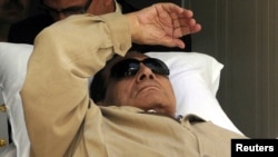 Former Egyptian President Hosni Mubarak is wheeled out of the courtroom after his trial in Cairo on June 2.