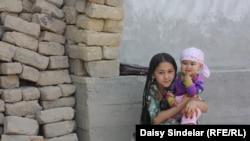 Ten-year-old Madina, an ethnic Uzbek, holds her niece in the courtyard of her family home in an Uzbek mahalla in the southern Kyrgyz city of Osh. Her family’s home was destroyed by fire in the June 2010 ethnic clashes.