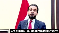 This handout video grab taken from live footage released by the Iraqi Parliament on September 15, 2018 shows newly-elected parliament speaker Mohamed Al-Halbusi addressing the chamber in the capital Baghdad. Halbusi, the candidate of the pro-Iran block.