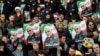Mourners in Mashad hold placards depicting Qasem Soleimani on January 5